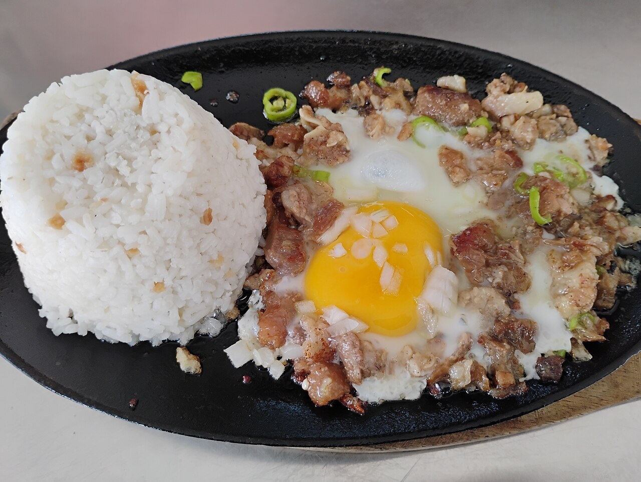 Sisig Fried Rice with Crispy Pork and Egg - Pork sisig with egg.