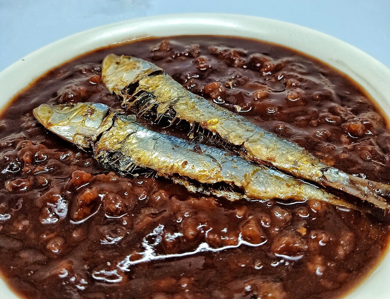 Champorado: Filipino Chocolate Rice Porridge - Champorado and tuyo close-up.