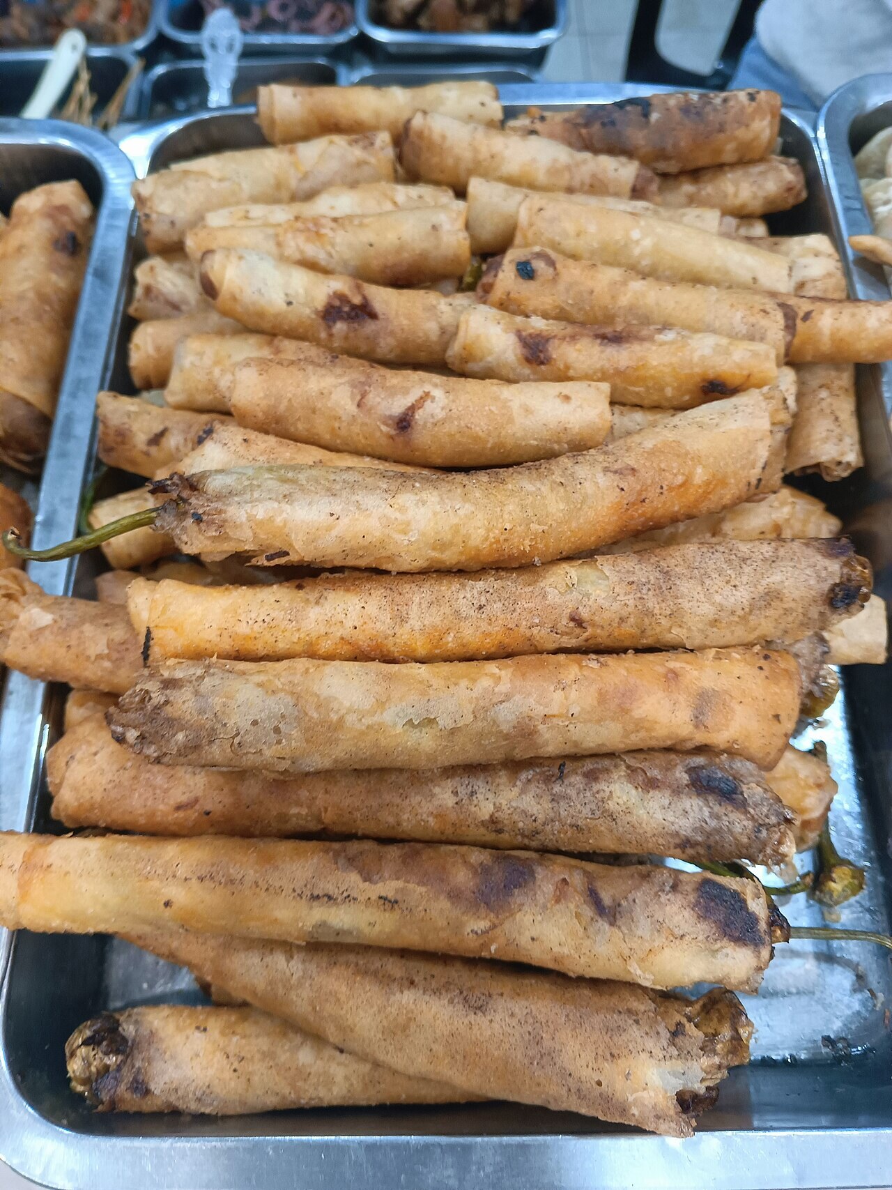 Dynamite Lumpia: Cheese-Stuffed Chile Spring Rolls - Dynamite lumpia is a popular Filipino street food made from whole green chili peppers, usually stuffed with cheese or.