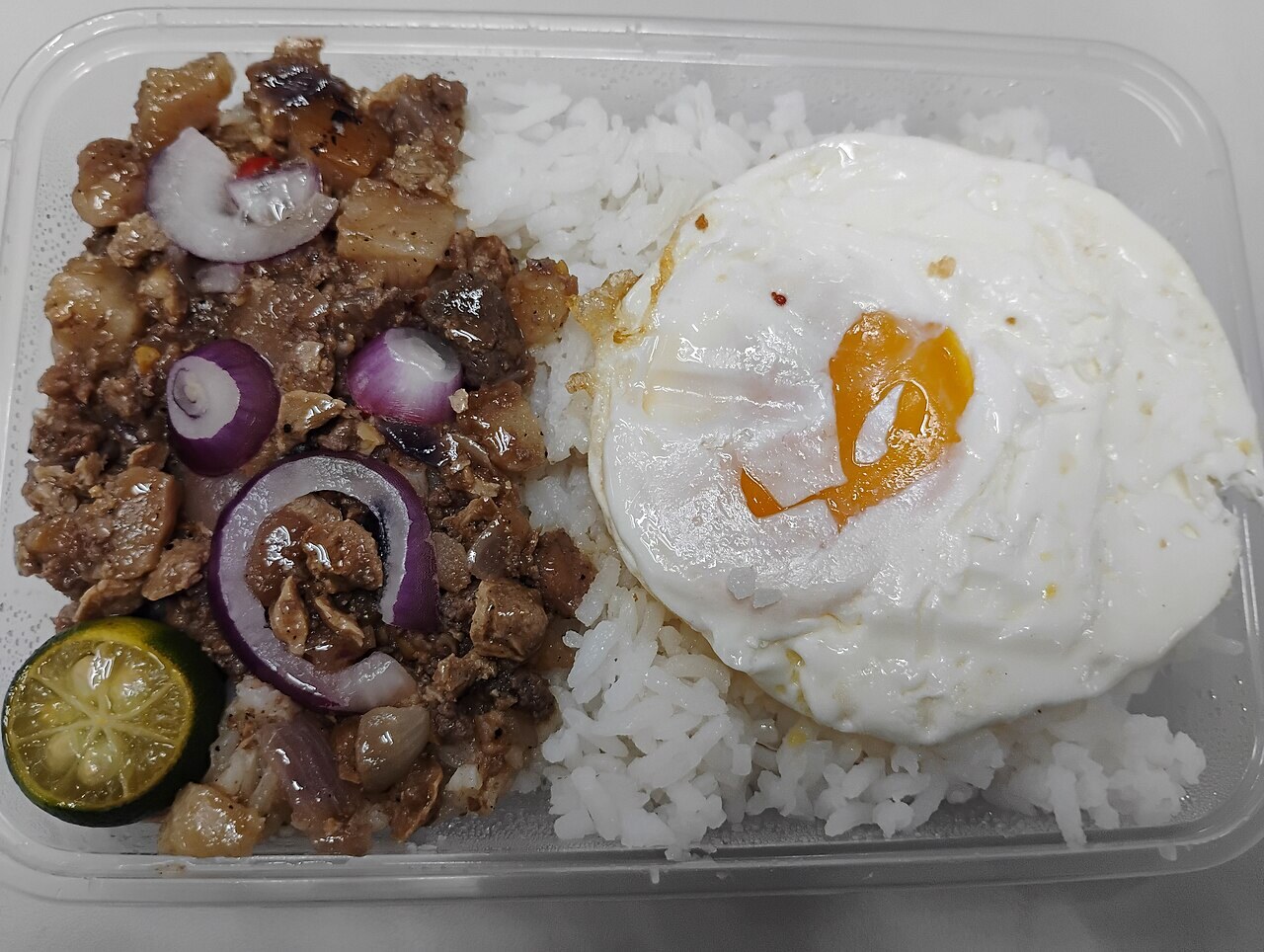 Sisig Fried Rice with Crispy Pork and Egg - Sisig egg meal for a fried-rice-style article.