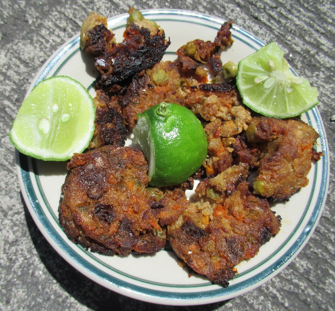 Embutido: Filipino Party Meatloaf with Eggs and Raisins - Fried Filipino Embutido ( garnished with Dayap (Philippines) ( Citrus x javanica Blume ) taken in Barangay Poblacion,.