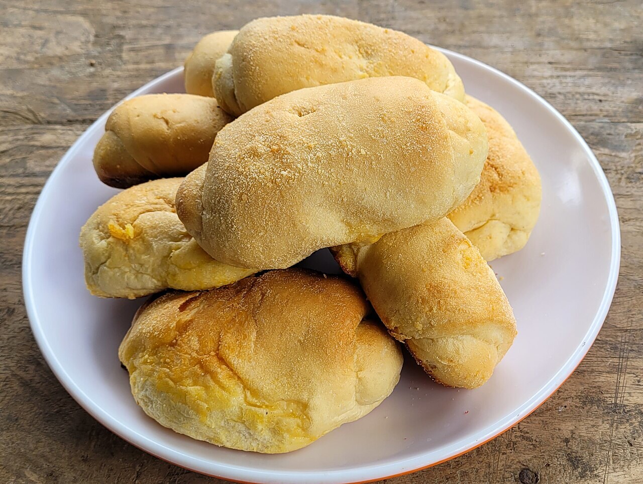 Spanish Bread: Filipino Bakery Rolls with Buttery Filling - Spanish bread served on a plate.