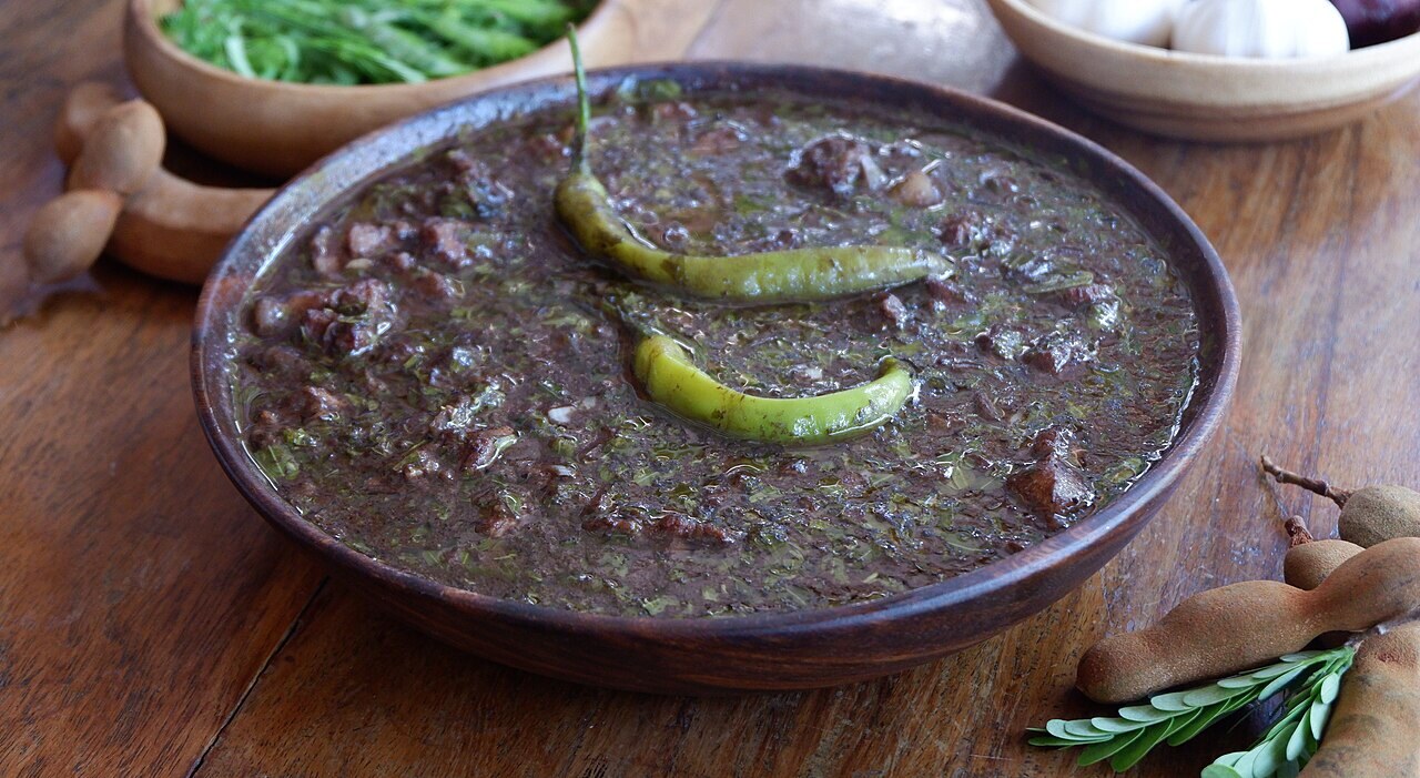 Dinuguan with Puto: Filipino Savory Pork Blood Stew - Tinumis - Nueva Ecijano's dinuguan. This pork blood stew uses tamarind fruit and leaves (usbong ng sampaloc) instead.