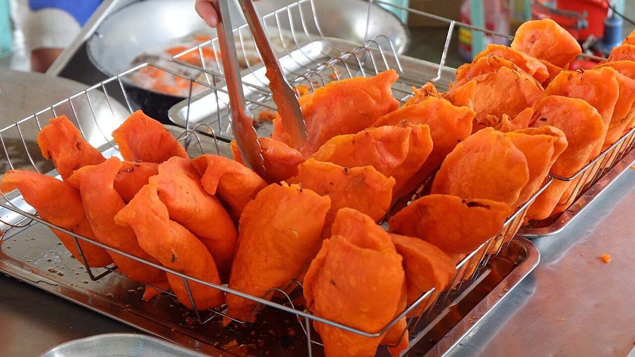 Ilocos Empanada: Crispy Orange Empanada with Longganisa and Egg - Ilocos empanada is a fried dish made with orange-tinged galapong or rice flour wrapper stuffed with vegetables (usual.