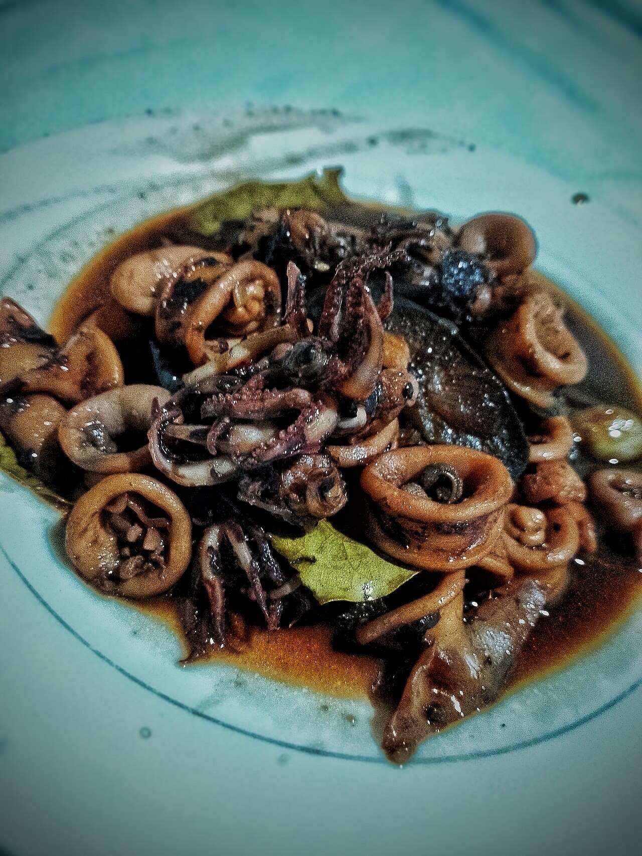 Adobong Pusit: Squid Adobo with Ink - Adobong pusit: Filipino dish with tender squid cooked in a savory blend of vinegar, soy sauce, garlic, and spices for.