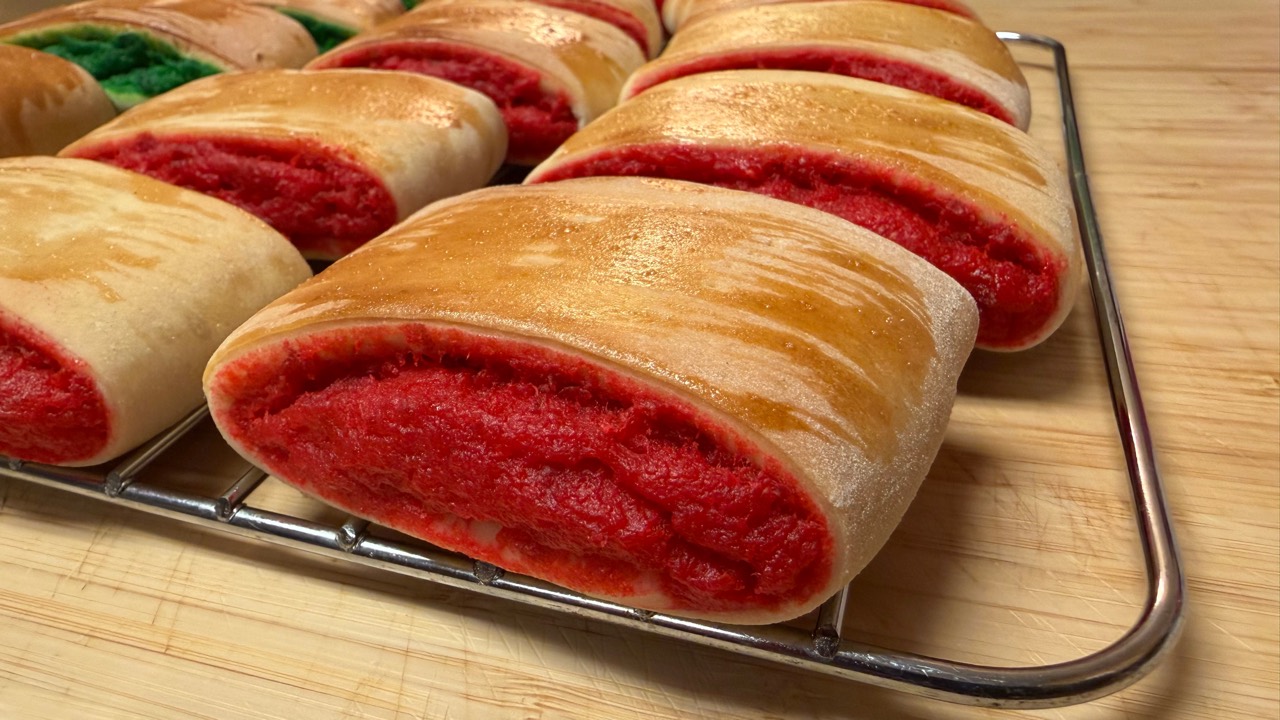 Burikat Filipino bread cooling on a rack with bright red pudding filling