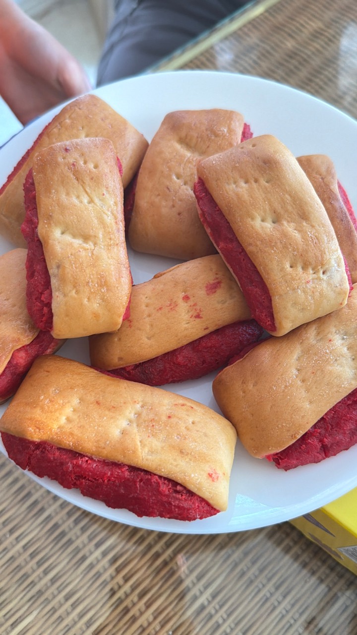 Burikat bread pieces with red pudding filling served on a white plate