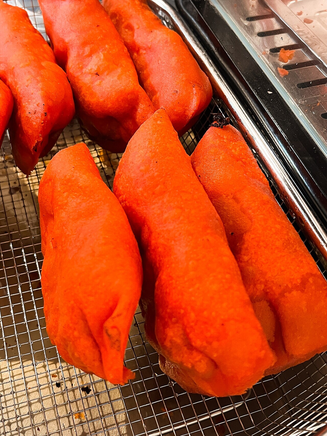 Ilocos Empanada: Crispy Orange Empanada with Longganisa and Egg - The basic Ilocos empanada has a rice or galapong wrapper stuffed with shredded green papaya.